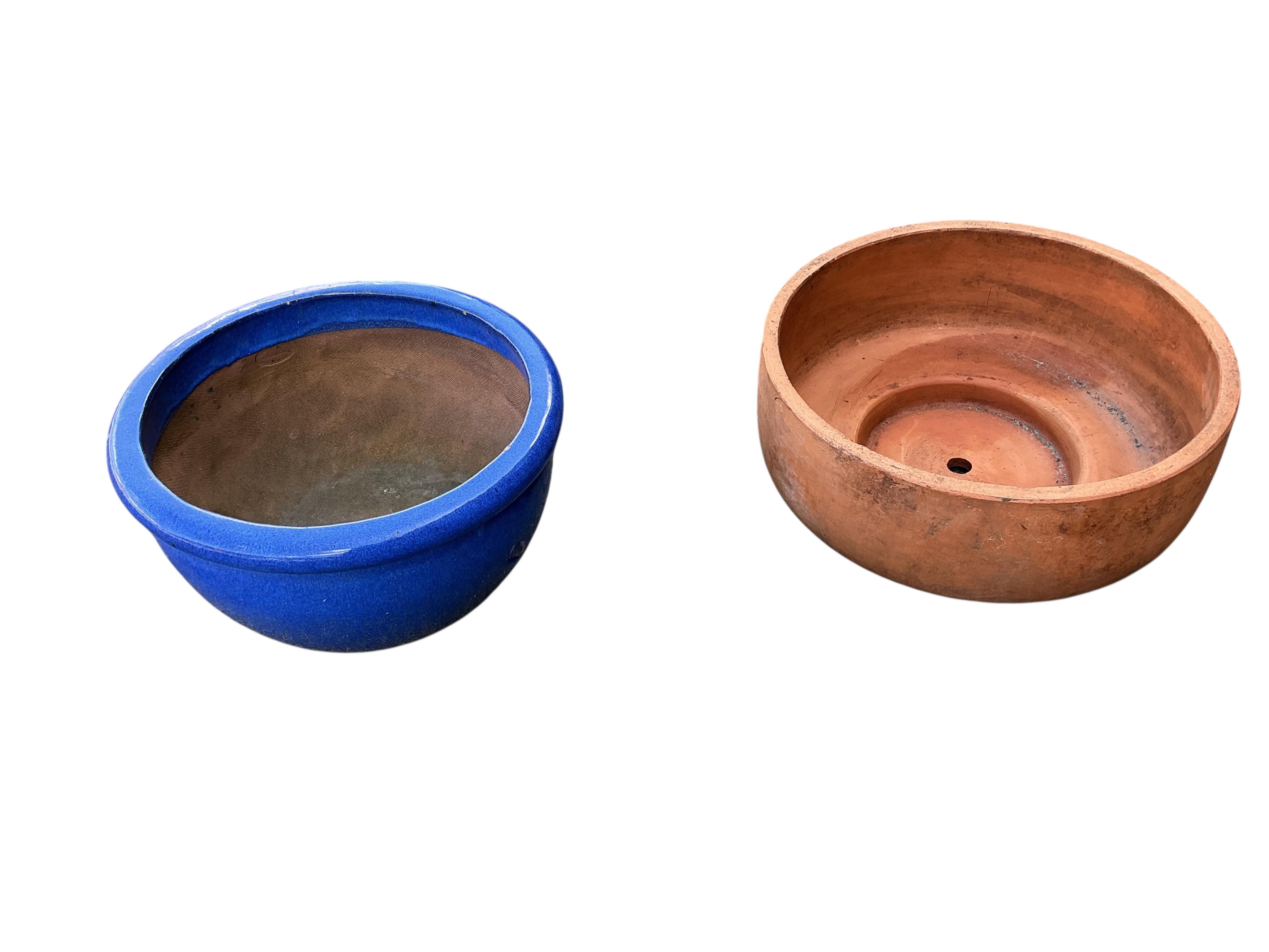 Three terracotta pots and a blue glazed pot, largest diameter 50cm, height 21cm